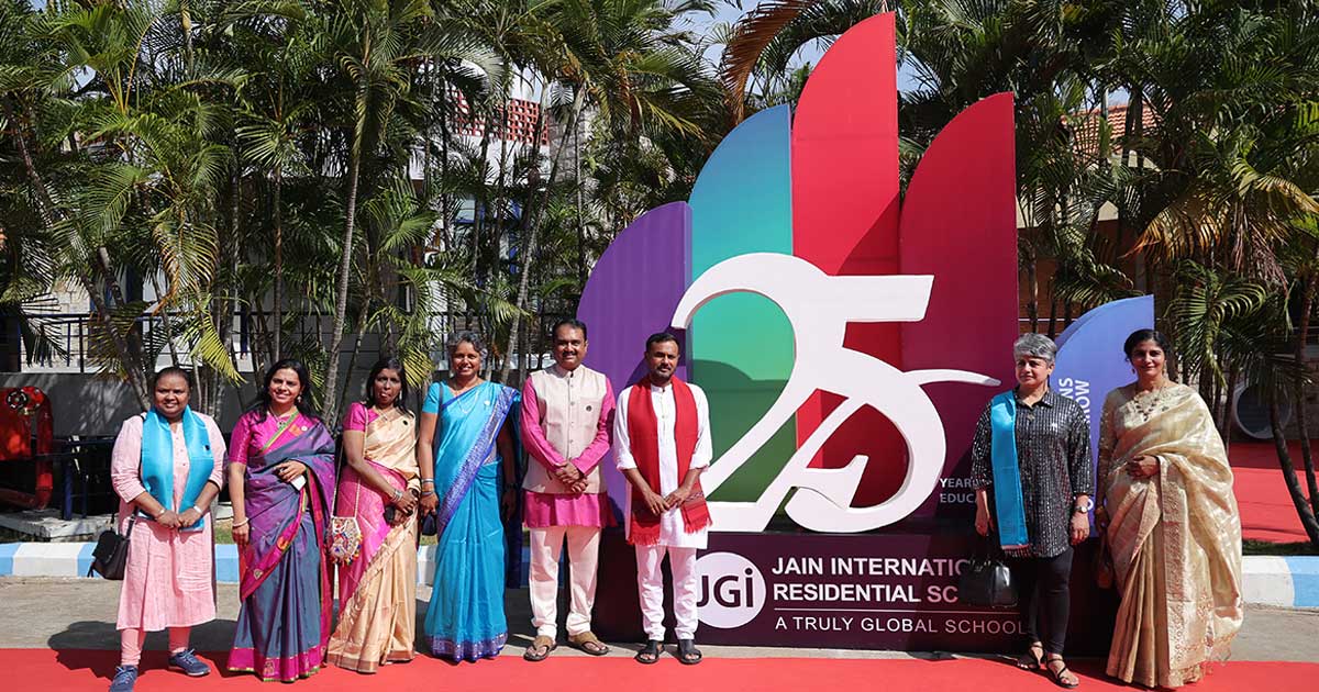 Group celebrating Jain International Residential School's 25th anniversary at Afflatus 2023.