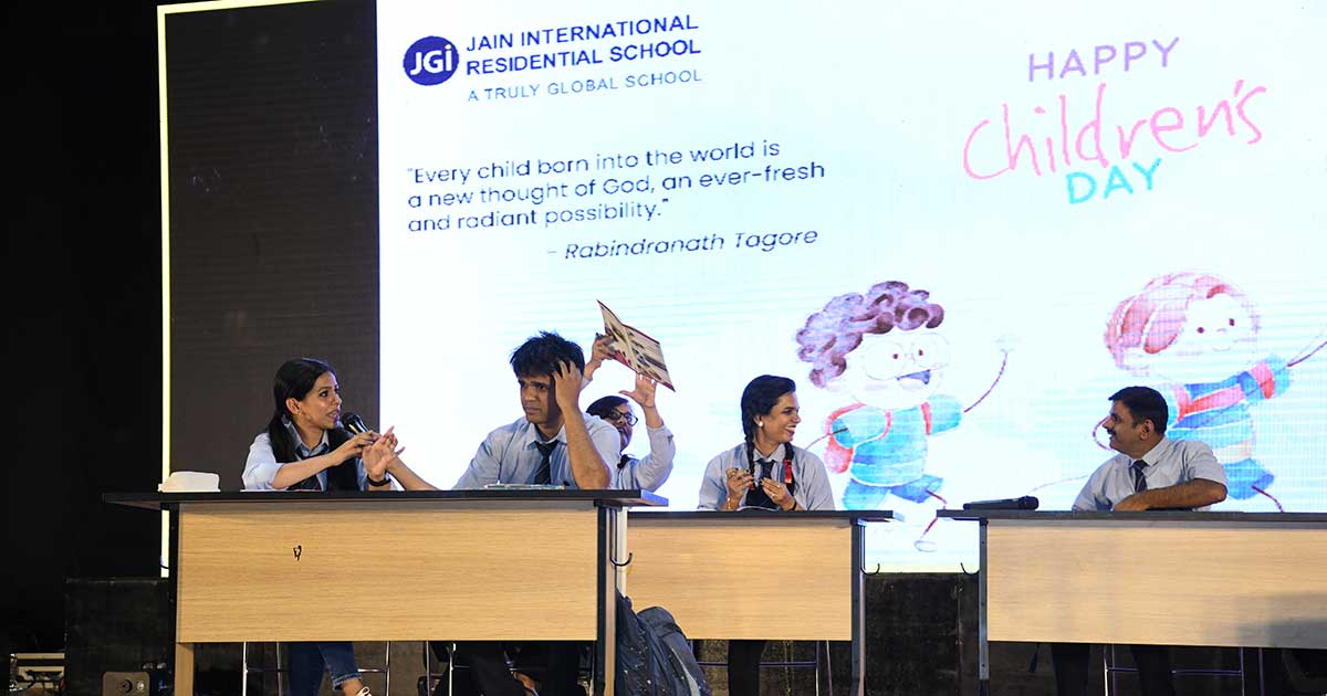 Discussion during Children's Day 2023 at JIRS with a quote by Tagore on a large screen.