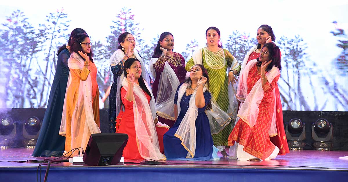 en women in colorful outfits performing joyfully on stage during Children's Day 2023 at JIRS.