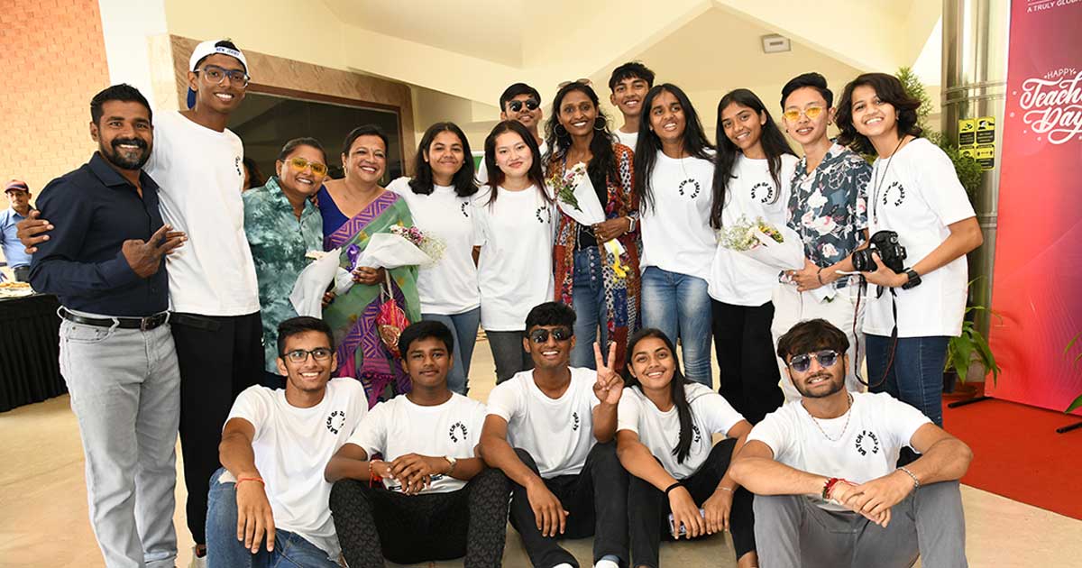 Group photo of students and teachers celebrating Teacher's Day 2023 at JIRS, with smiles and flowers.
