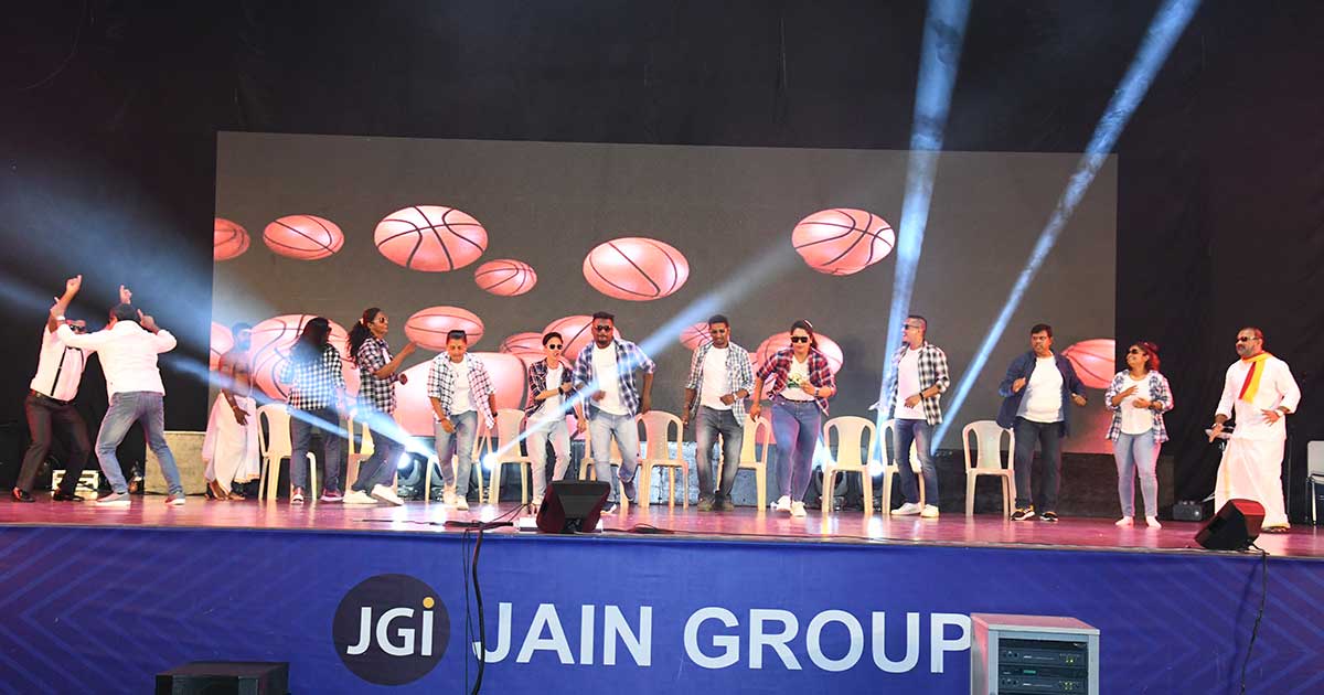 Casual performers dancing on stage with animated basketballs during Children's Day 2023 at JIRS.