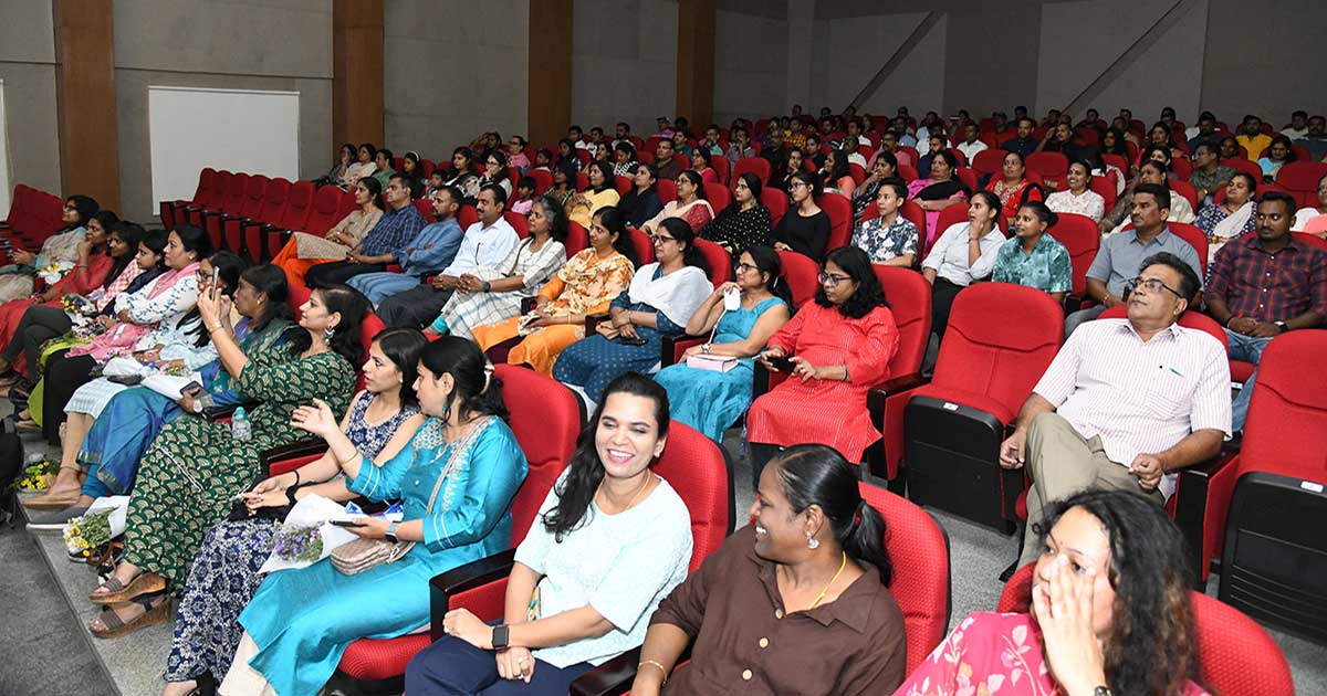 Diverse audience seated in a modern auditorium during the Teacher’s Day celebrations at JIRS.